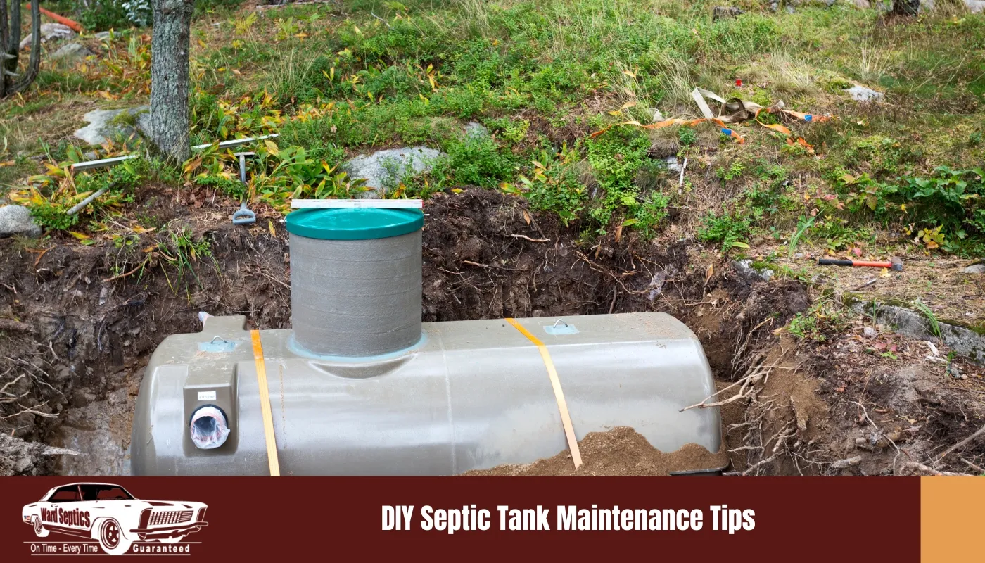 A light-coloured, horizontal septic tank being installed in a dirt pit