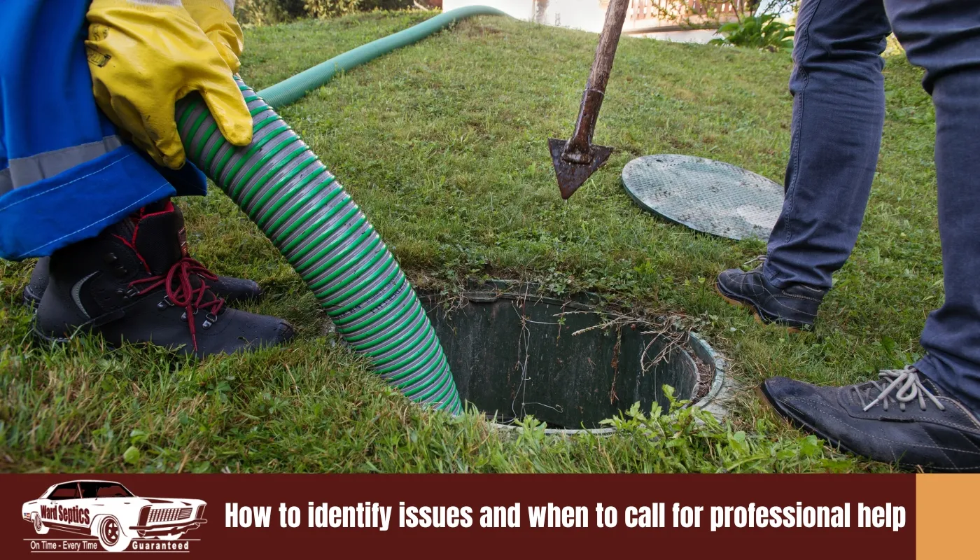 A worker in yellow gloves inserting a large green suction hose into a septic tank's open ground-level access hole.