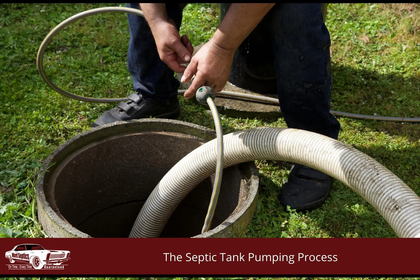 A worker's hands manipulating hoses inside an open, circular septic tank access hole.