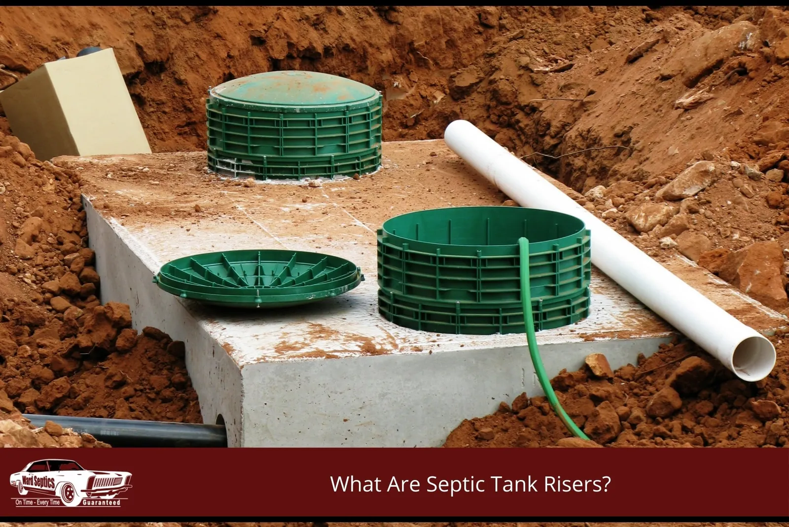 A concrete septic tank installed in a dirt pit, featuring two green plastic risers.