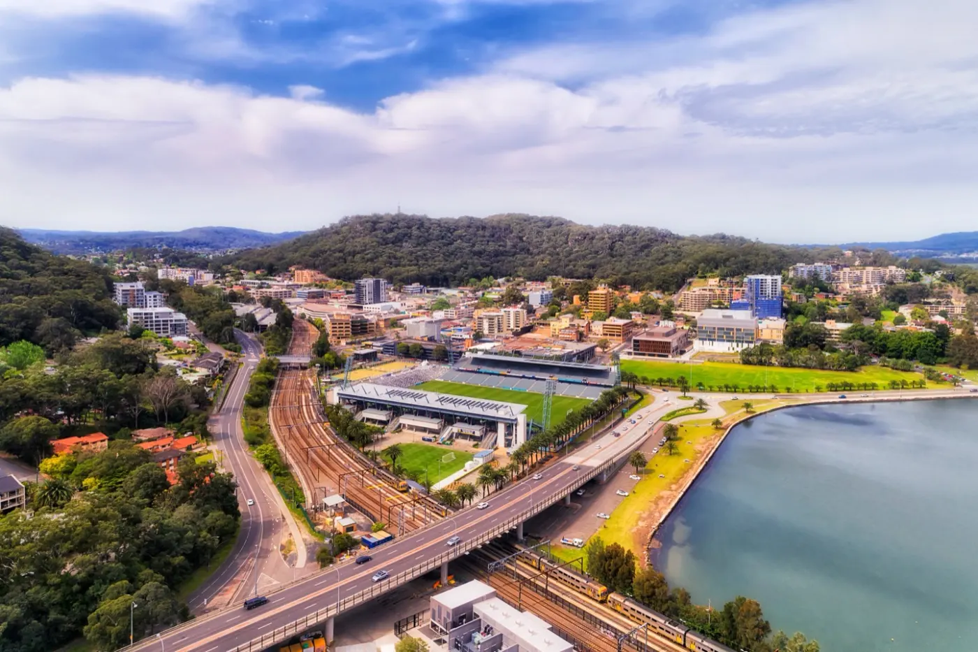 Aerial view of Gosford town centre on Brisbane Water with bushland rising on the ridge behind