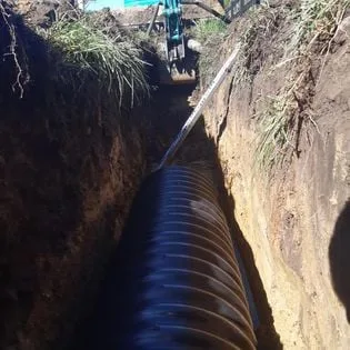 A new absorption trench with corrugated pipe laid in an open excavation