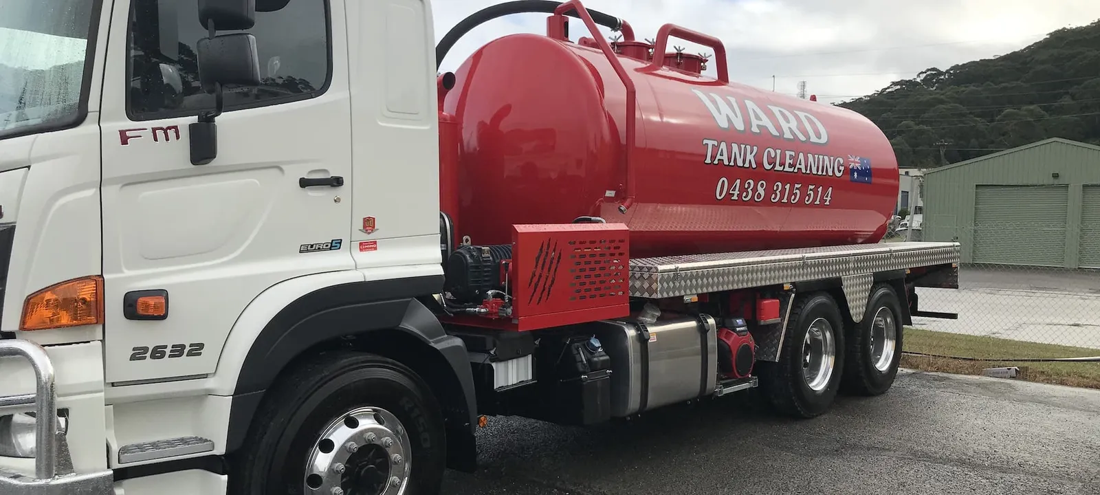 The Ward Tank Cleaning truck side-on, tank lettering and hoses in view