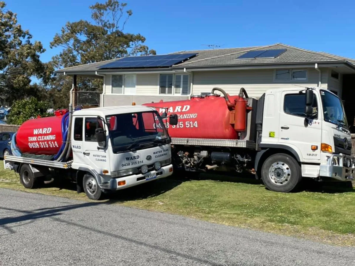 Both Ward trucks parked at a Central Coast home for a tank cleaning job